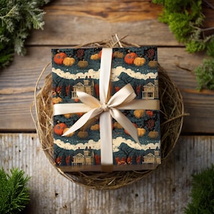 May include: A wrapped gift box with a cream-colored ribbon. The wrapping paper features a pattern of orange and yellow pumpkins, houses, and trees on a dark blue background. The gift is presented on a woven nest.