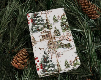 May include: A white gift wrap with a winter scene featuring houses, trees, and red berries. The paper is tied with twine.