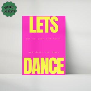 Op de afbeelding: Een felroze poster met de woorden "LETS DANCE" in grote gele letters. De tekst "put on your red shoes and dance the blues" staat in kleinere gele letters. De poster heeft een "Bambs Designs" logo in de linkerbovenhoek.
