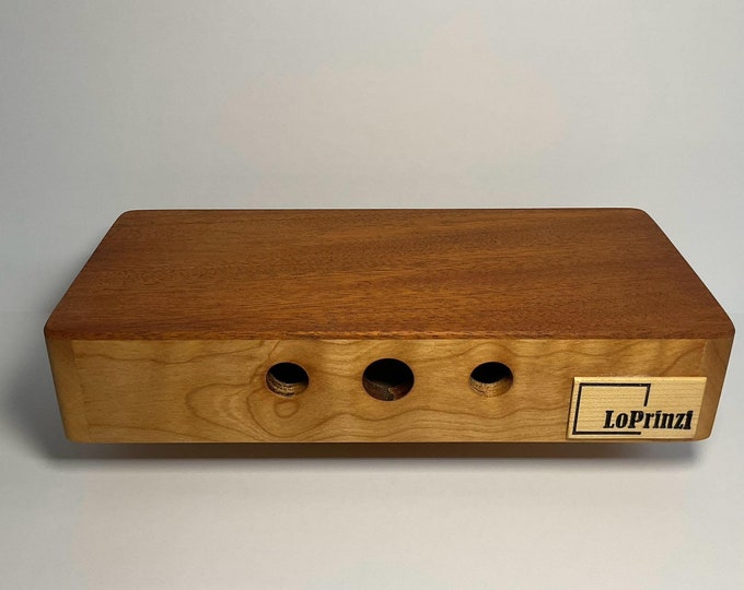 Travel size cajon hand drum.  A compact percussion instrument measuring 10”x4.75”x2”.