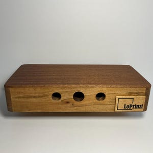 Travel size cajon hand drum with snare.  A compact percussion instrument measuring 10”x4.75”x2”.