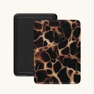 Op de afbeelding: Zwarte e-reader hoes met een donkerbruin en beige abstract patroon op de voorkant. De hoes is open en toont de zwarte binnenkant en achterkant. Het ontwerp lijkt op een geologische formatie.