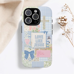 May include: A phone case with a patchwork design featuring a cross, flowers, and a lighthouse. The case has the text "LOVE LIKE JESUS", "How lucky are we", and "God is within her, she will not fail". The case has a blue bow.