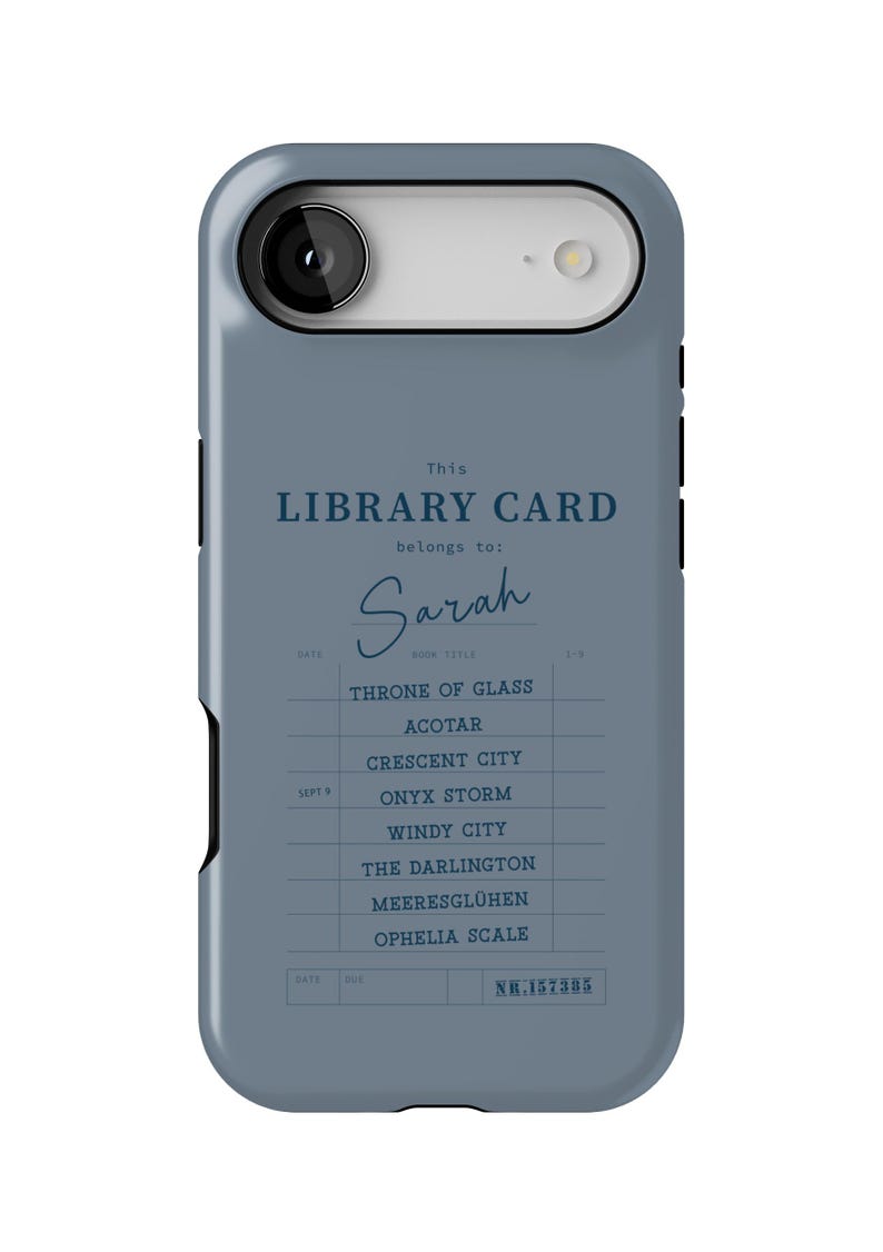May include: A blue phone case featuring a library card design. The text reads "This LIBRARY CARD belongs to: Sarah." Below are book titles like "Throne of Glass" and "Crescent City." The case has a camera cutout.