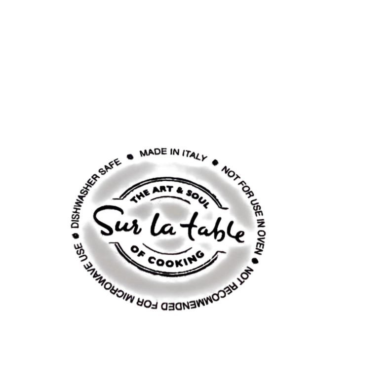 May include: A circular logo with the text "Sur la table" in a stylized script, surrounded by text indicating it's made in Italy, dishwasher safe, and not for oven or microwave use. The logo also includes "The Art & Soul of Cooking."
