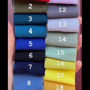 Twenty numbered swatches of fabric in various colors, including red, green, blue, yellow, and purple, are arranged in rows.