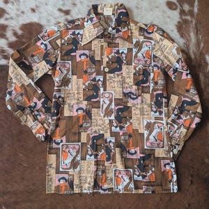 May include: A long-sleeved button-down shirt with a repeating pattern of vintage illustrations in brown, tan, and orange. The shirt features a classic collar and buttoned cuffs, showcasing a retro aesthetic.