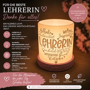 May include: A cylindrical frosted glass candle holder with a warm internal glow, resting on a pink base with a leaf pattern. The glass features brown text including the word LEHRERIN and terms like Schule, Wissen, Inspiration, and Mentor.
