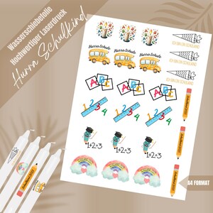May include: A sheet of colorful stickers featuring school-themed designs. The stickers include a school bus, pencils, rulers, rainbows, and the letters ABC. The text "Hurra Schulkind" is printed on the sheet.