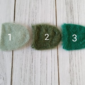 May include: Three fuzzy yarn squares in different shades of green. The squares are labeled 1, 2, and 3.