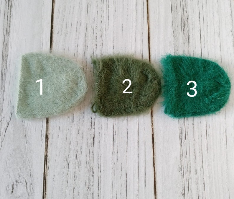 May include: Three fuzzy yarn squares in different shades of green. The squares are labeled 1, 2, and 3.