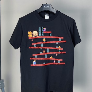 スーパーマリオ 2006 ヴィンテージ グラフィックプリント クルーネック Tシャツ • 任天堂|プレイステーション|Xbox ゲーム • 1990年代 コンピュータゲーム Tシャツ • USA ヴィンテージ 90年代