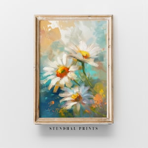 Puede incluir: Una pintura de margaritas blancas con centros amarillos sobre un fondo azul y naranja. La pintura está enmarcada en un marco de madera claro.