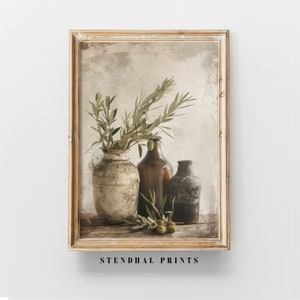 May include: A still life photograph featuring a rustic, white ceramic vase filled with olive branches and green olives. The vase is positioned next to two brown glass bottles, one with a cork stopper and the other with a metal lid. The background is a textured, beige wall with a faded, vintage aesthetic.