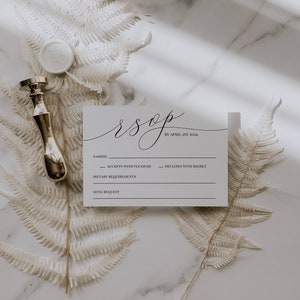 May include: A white RSVP card with black text. The card has a section for the guest's name, a section for accepting or declining the invitation, a section for dietary requirements, and a section for a song request. The text on the card reads "rsvp by April 1st 2024".