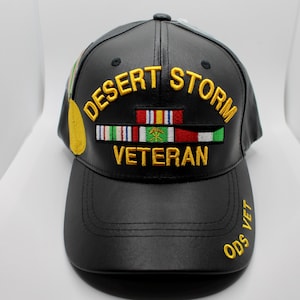 May include: Black leather baseball cap with gold embroidery that reads "Desert Storm Veteran" and "ODS VET". The cap features a row of colorful ribbons.