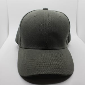 May include: A solid gray baseball cap with a curved brim. The cap has a structured design with a button on top and a stitched brim. The fabric appears to be a durable, woven material.
