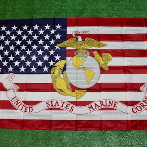 May include: A United States Marine Corps flag featuring the American flag design with the Marine Corps emblem. The flag has a blue field with white stars, red and white stripes, and the Marine Corps emblem in gold.