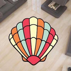 Könnte beinhalten: Ein bunter Muschelteppich mit einem rot-orange-gelb-blauen Streifenmuster. Der Teppich ist muschelförmig und hat einen weißen Hintergrund.