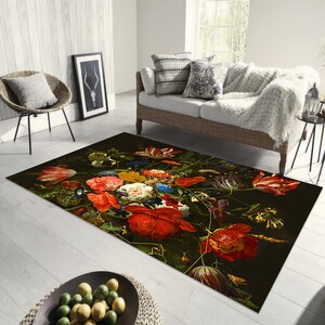 May include: A dark brown area rug with a floral design featuring red, yellow, white, and blue flowers. The flowers are arranged in a bouquet and are surrounded by green leaves.