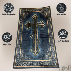 May include: A navy blue rug with a gold Orthodox cross design. The rug has a gold floral border and features icons indicating it is anti-bacterial, washable, non-slip, and has a soft surface.