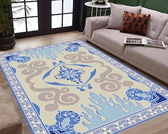 May include: A beige rug with a blue and gray pattern. The pattern features stylized flames, swirls, and a floral design. The rug has a blue border with a repeating geometric pattern.