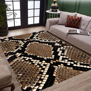 May include: A brown and black snake skin patterned rug with a geometric design. The rug is laid out on a wooden floor in a living room setting.