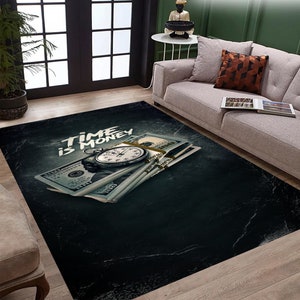 May include: A black and green rug with a design of a stopwatch on top of a stack of dollar bills. The text "TIME IS MONEY" is written in white on the rug.