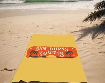 May include: A yellow beach towel with the text "SUN BURNS and SUNSETS" in a vintage style font. The text is surrounded by palm trees and a sunset graphic.