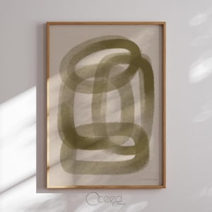 May include: Abstract art print featuring overlapping olive green oval shapes on a beige background. The artwork is framed in a light brown wooden frame. The print has a minimalist aesthetic and is suitable for home decor.