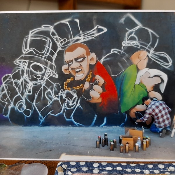 blank greetings card with photo featuring Cheo using spray paints to create street art at Yardworks, Glasgow 2017