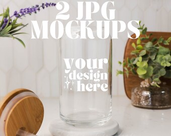 May include: Two clear glass jars with bamboo lids and straws. The jars are on a white surface with a white coaster. The text "your design here" is printed on the front of the jar.