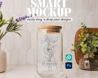 May include: A clear glass 16 ounce tumbler with a bamboo lid and a straw. The tumbler has a floral design and the text "16 ounces" printed on the side.