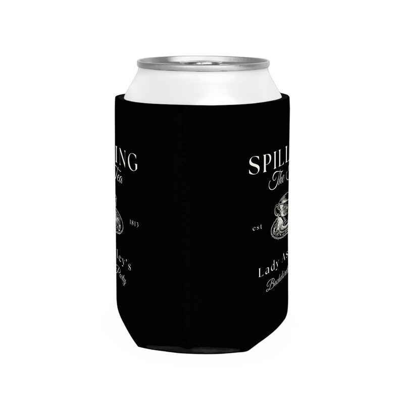 May include: Black can cooler with white text that reads "Spilling The Tea est. Lady As A Bottle Service" with a small illustration of a teacup and saucer.
