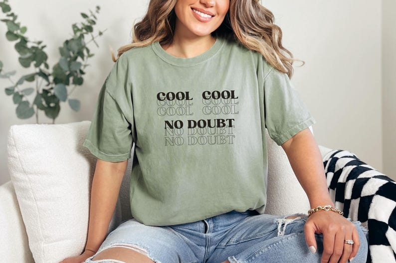 May include: A green t-shirt with the text "Cool Cool Cool Cool No Doubt No Doubt No Doubt" printed on the front.
