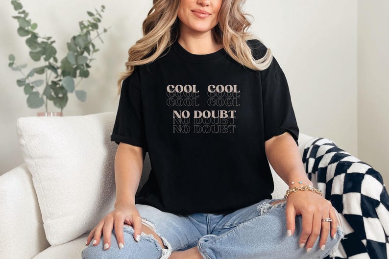 May include: A black t-shirt with the text "COOL COOL COOL COOL NO DOUBT NO DOUBT NO DOUBT" in a retro font.