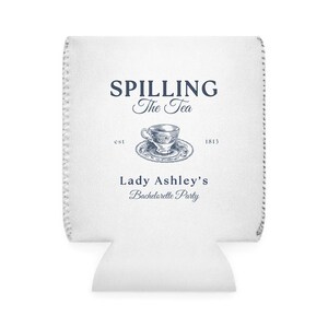 May include: White can cooler with a blue and white teacup illustration and the text "Spilling The Tea est 1813 Lady Ashley's Bachelorette Party".