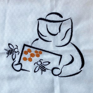 May include: Black and white line drawing of a beekeeper wearing a beekeeper's hat and holding a frame of honeycomb with bees. The honeycomb is orange.