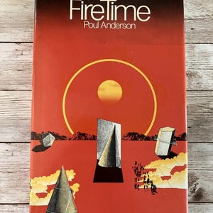 May include: A red paperback book with the title "FireTime" by Poul Anderson. The cover features a stylized illustration of a sun, a desert landscape, and geometric shapes.