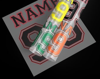 May include: A close-up of heat transfer vinyl rolls in yellow, black, green, and orange, with the number 99 and the word NAME visible. The vinyl is on a gray sheet with the number 99 and the word NAME in black and red.