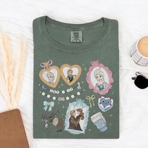 a green t-shirt with various cartoon characters and illustrations, including a heart, a cup, a mug, and a pair of sunglasses, all arranged on a white surface.