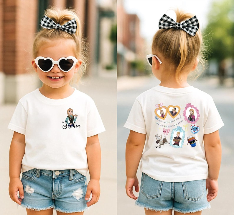 A young girl wearing a white t-shirt with a cartoon character and heart-shaped sunglasses, along with denim shorts and a bow in her hair.