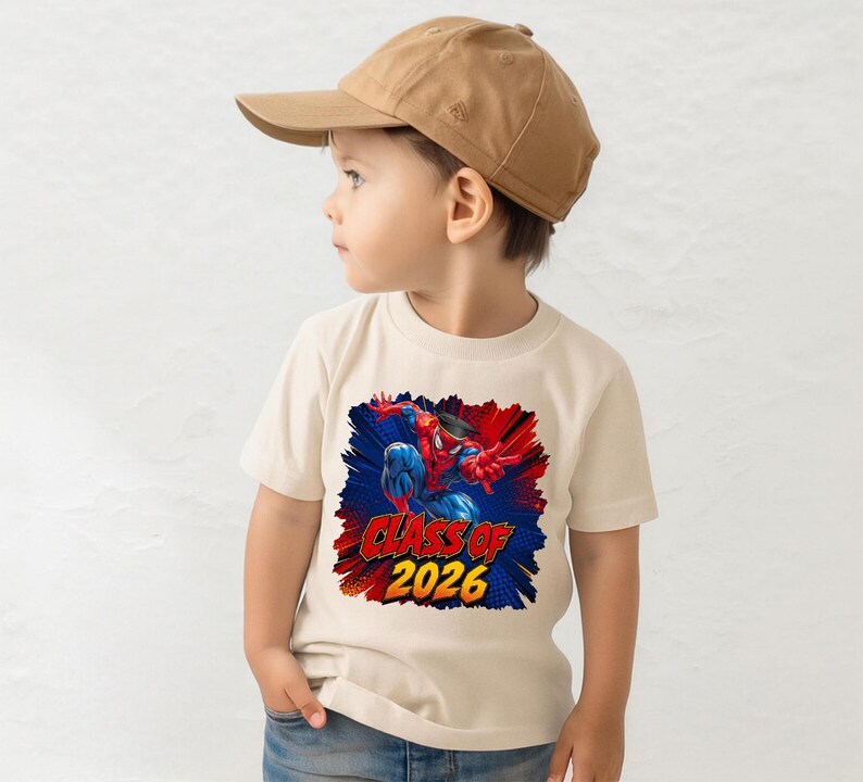A young boy wearing a baseball cap and a t-shirt with a graphic of Spider-Man.