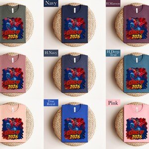 The image is a collage of nine t-shirts, each with a different color and design, arranged in a 3x3 grid. The t-shirts feature the same design, which includes a Spider-Man image and the text "CLASS OF 2026".