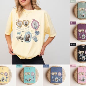 A woman wearing a yellow t-shirt with various illustrations and text, including a heart, a cup, and other decorative elements.