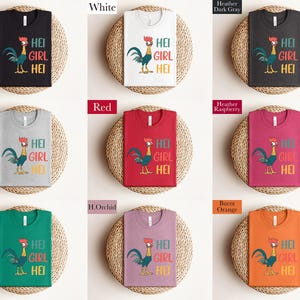 a collection of t-shirts with a colorful rooster design, each in a different color and size.