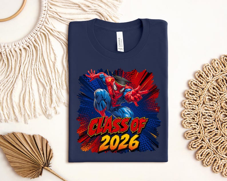 A navy blue t-shirt with a graphic design featuring a Spider-Man character and the text "CLASS OF 2026" printed on it.