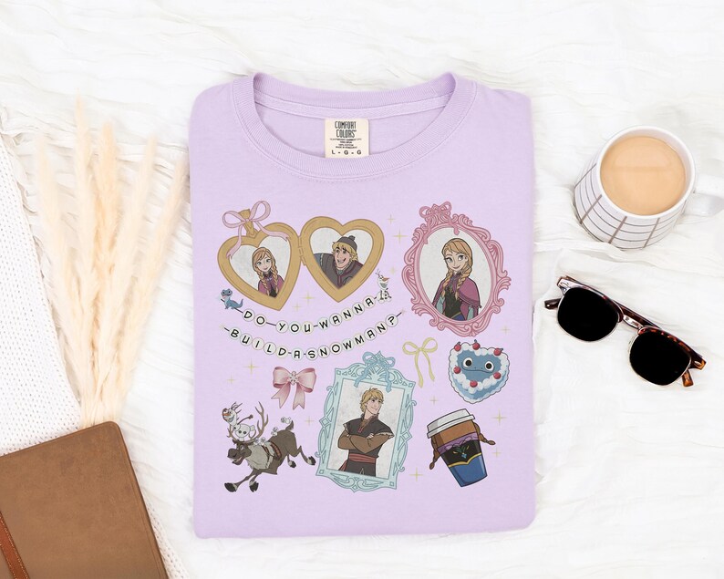 a purple t-shirt with various cartoon-style illustrations and text, including a heart-shaped character, a cup, sunglasses, and other objects.