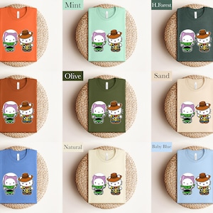 The image is a collage of nine different t-shirt designs featuring cartoon characters, each with a unique color and style.