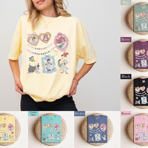 A woman wearing a yellow t-shirt with various cartoon characters and designs, including a pink t-shirt, a black t-shirt, and a pink t-shirt.